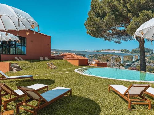 a resort with a swimming pool and lounge chairs at The Lost Garden in Vila Nova de Gaia