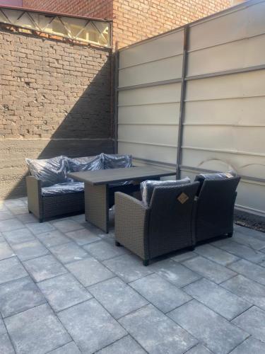 a table and chairs sitting on a patio at Discovery Garden apartments in Khmelʼnytsʼkyy
