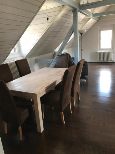 a wooden table and chairs in a room at Ferienwohnung zentrale ruhige Lage auch gerne mit Kindern in Arbon