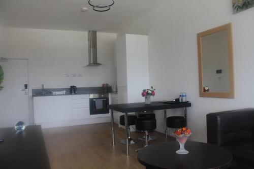 a living room with a table and some chairs at Flat 413 One bedroom apartment in Birmingham