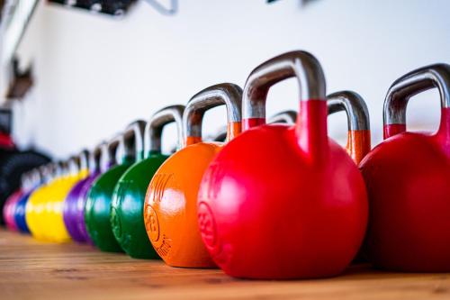 a row of colorful bowling pins lined up on a table at Kyuka Surfclub in Lajares