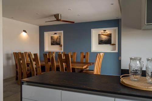 a dining room with a table and chairs at Kyuka Surfclub in Lajares