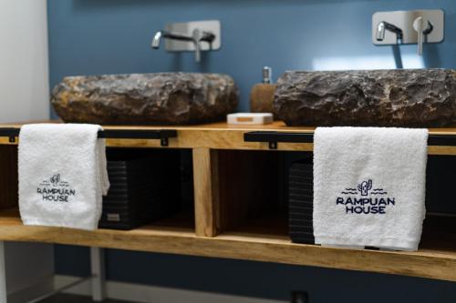 a shelf with towels and rocks on it at Kyuka Surfclub in Lajares