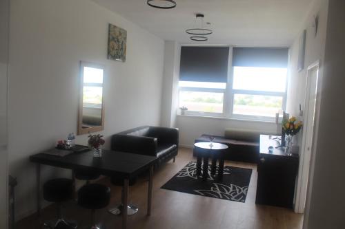 a living room with a table and a couch at Flat 413 One bedroom apartment in Birmingham