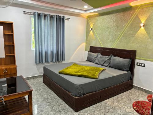 a bedroom with a bed with a yellow pillow on it at Mountainmist Holidays in Ramakkalmedu