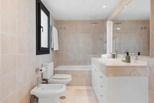 a bathroom with a toilet and a sink and a mirror at Sky And Sea Estepona Penthouse in Estepona