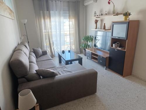 a living room with a couch and a flat screen tv at Puerto Barrio Alto in El Puerto de Santa María