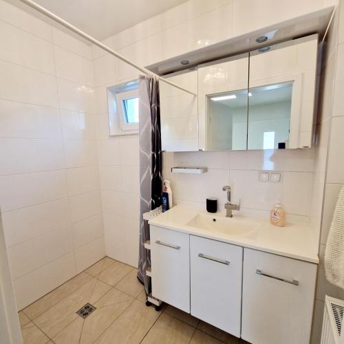 a bathroom with a sink and a mirror at Ferienwohnungen Kres in Gamlitz