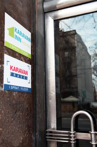 a sign on the side of a building with a window at Hostel Karavan Inn in Belgrade