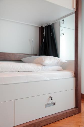 a bedroom with two white beds with white pillows at Hostel Karavan Inn in Belgrade