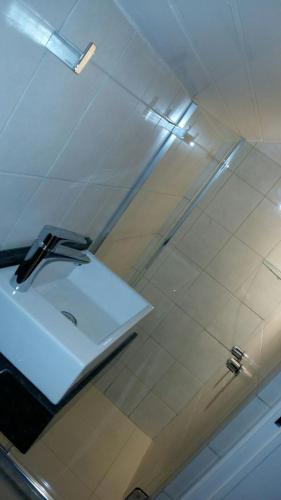 a bathroom with a sink and a shower at Duplex em Gramado in Gramado