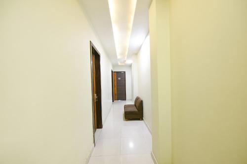 a hallway with a chair in a building at FabHotel KK Continental 50 Meter from Railway Station - Amritsar in Amritsar