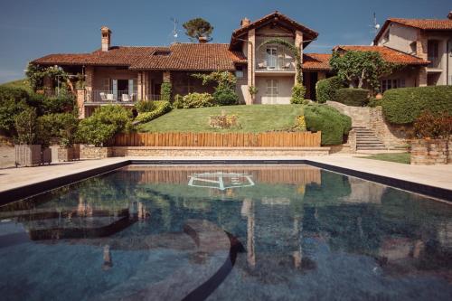 a house with a swimming pool in front of a house at Scarpa Villas - Barolo Luxury Escape in Verduno