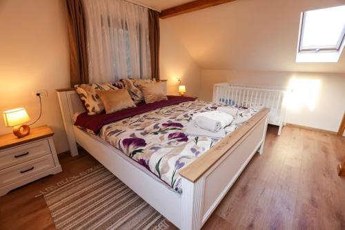 a bedroom with a large white bed and a window at Luxury Love Cottage Spa- privatni jacuzzi &sauna , mir i privatnost in Velika Gorica