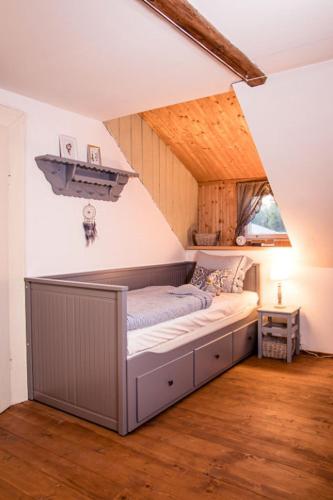 a bed in the corner of a room at Chalupa Tulipánka in Krásná Lípa