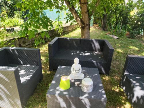 a table with a doll sitting on top of it at Studio Goya climatisé et jardin 2 nuits minimum in Castres