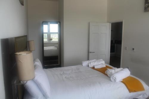 a bedroom with a large white bed with towels on it at Flat 409 One bedroom apartment in Birmingham