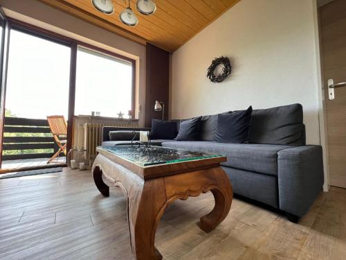 a living room with a couch and a table at Ferienwohnung Hexenstieg in Sankt Andreasberg