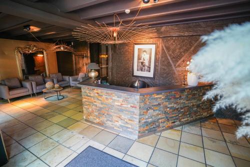 a lobby with a stone counter in a room at Hôtel Au Comte de Mercy in Oupeye