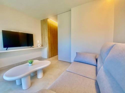 a living room with a couch and a table at Piscina Chic con gran Terraza in Murcia