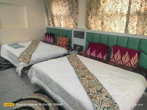 a room with two beds in a room at Kashmir Group of Hotels and Resorts in Srinagar