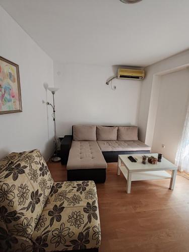 a living room with a couch and a coffee table at Happy house in Kruševac