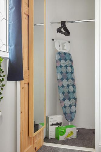 a skateboard is hanging on a wall next to a shelf at Kent Haven - 3 bed house, Games room and Parking in Kent