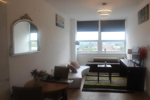 a living room with a couch and a table at Flat 404 One bedroom apartment in Birmingham