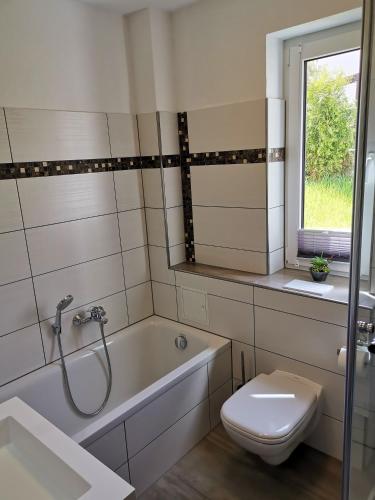 a bathroom with a tub and a toilet and a sink at Apartment in Papstdorf "Sachsenstiege" in Papstdorf