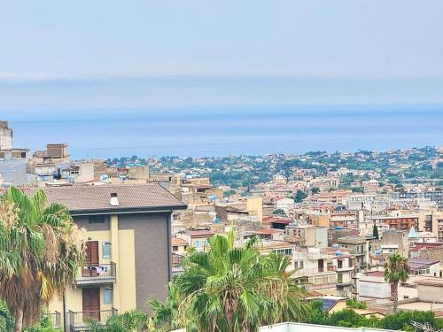 a view of a city with buildings and palm trees at Bay View Wi-Fi-Vista Mare-Free Parking in Carini
