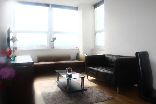 a living room with a couch and a table at Flat 405 One bedroom apartment in Birmingham
