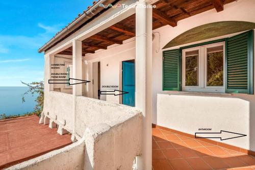 a house with a balcony with a view of the ocean at Blu Isola, Terre Marine in Corniglia
