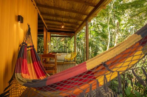 a hammock on a porch of a house at Pousada Sitio Raizes in Siderópolis