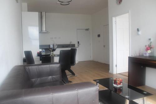 a living room with a couch and a table at Flat 405 One bedroom apartment in Birmingham