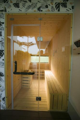 a sauna with a glass door in a room at Flamigo Dai Lai Resort - Villa Chủ Tự Doanh in Ngọc Quang