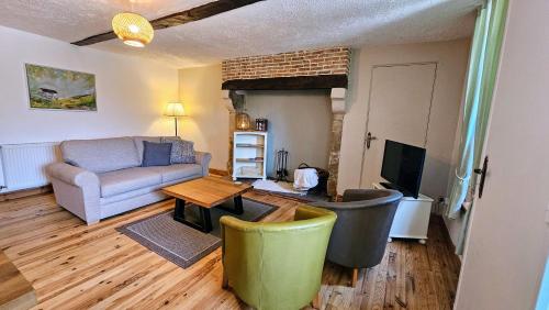 a living room with a couch and a table at Gite La Petite Colline in Pagéas