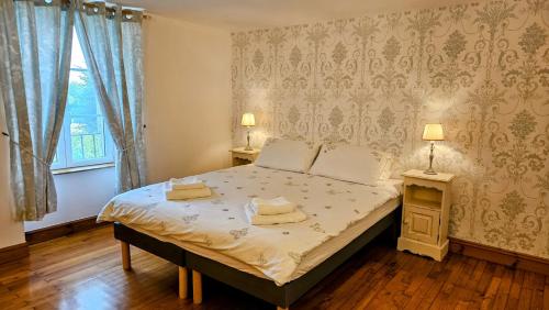 a bedroom with a bed with two towels on it at Gite La Petite Colline in Pagéas