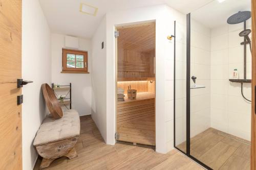 a bathroom with a shower and a bench in a room at Luxury Villa TINKA in Zgornje Gorje