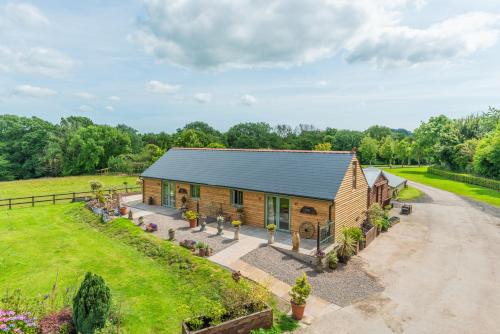 an image of a log cabin with a garden at Self-contained cosy one bedroom holiday barn in Cowbridge