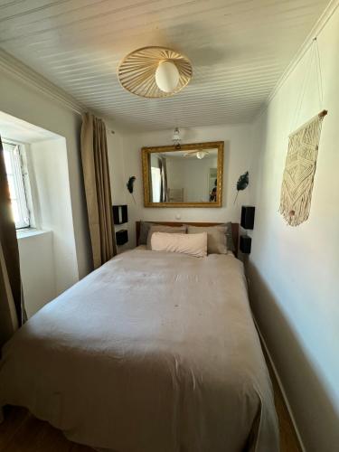 a bedroom with a large bed with a mirror at Castelo Terrace in Lisbon