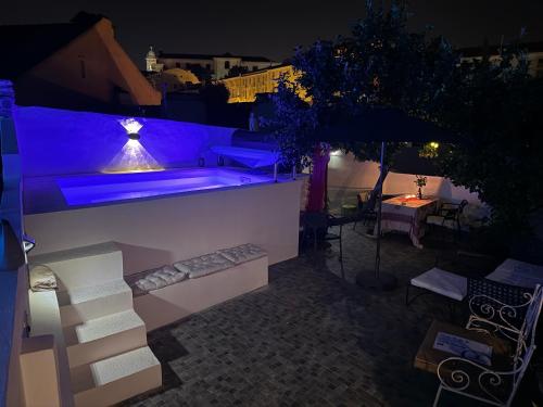 a swimming pool with blue lighting on a rooftop at night at Castelo Terrace in Lisbon