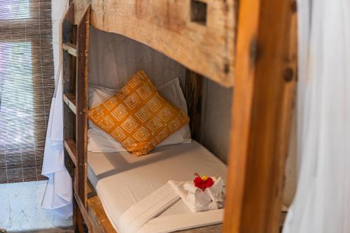 a bunk bed in a room with a pillow at Mr Kahawa in Paje