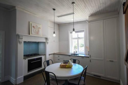 a kitchen with a table and a table and chairs at Gabby's Cottage in Clarendon