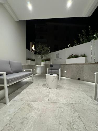 a room with a bench and a table in a building at Domus De Cinti Boutique Rooms in Tivoli