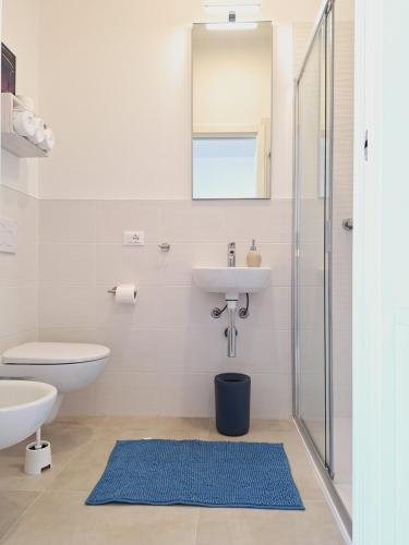 a bathroom with a sink and a toilet and a mirror at Re Lear Expo in Verona