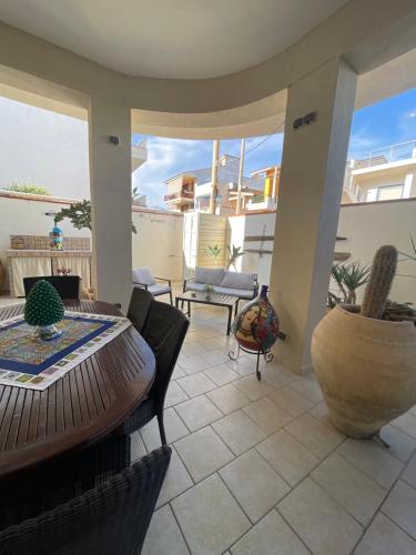 a patio with a table and chairs on a balcony at Villa Joseph in Marzamemi