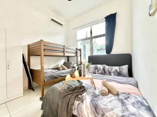 a bedroom with two bunk beds and a window at SD 1-10Pax Puchong Sky Pod Residence IOI Mall WiFi in Puchong