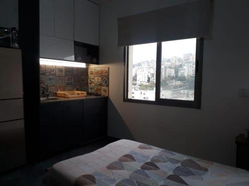 a bedroom with a bed and a window at Inviting 1-Bed Apartment in Dbayeh in Dbayeh