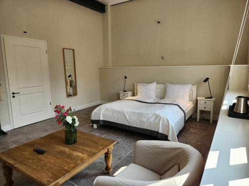 a bedroom with a bed and a table at Storchenhof Blumenow in Blumenow