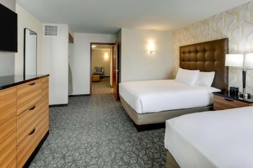 a hotel room with two beds and a television at Drury Inn & Suites Birmingham Lakeshore Drive in Birmingham